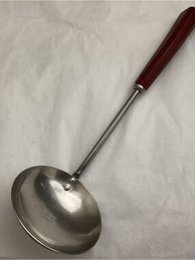 Vtg. Kitchen ladel, stainless steel, Red Bakelite handle Highly sought after.
